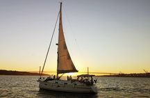 Small-group Lisbon sunset sailing cruise with a welcome drink