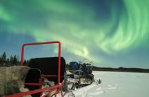 Northern lights sledge ride by snowmobile