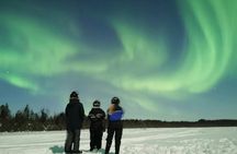 Northern lights sledge ride by snowmobile