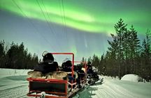 Northern lights sledge ride by snowmobile