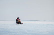 Snowmobile safari through Lappish forest