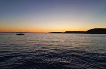 Golden hour boat tour with sunset views of Macarella in Menorca