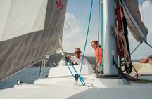 Sardinian coastline catamaran tour with multiple stops