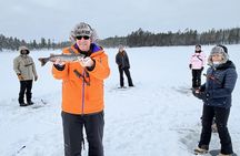 Ice fishing on frozen water with local guide