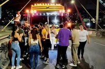 Medellín night tour on an open-air party bus with bar stop