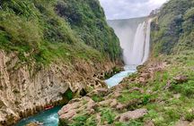 Tamul waterfall and water cave on a wooden canoe