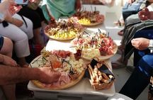 Aperitif on the boat at Sunset island and sea caves