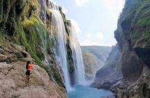 Tamul waterfall and water cave on a wooden canoe