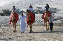 Full-day Qatar desert safari: dune bashing, sandboarding, camels