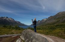 Tromso fjords road trip with fire in grill cabin by the beach.