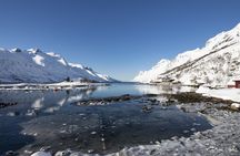 Tromso fjords road trip with fire in grill cabin by the beach.