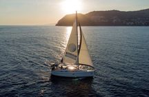 Sailing at sunset along the cliffs of Maro-Compartida