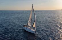Sailing at sunset along the cliffs of Maro-Compartida