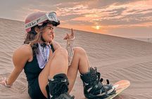 Sandboarding or Sandsky with sunset in Huacachina