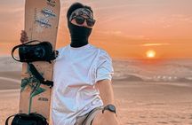 Sandboarding or Sandsky with sunset in Huacachina