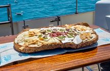 Sunset with dolphins and aperitif on a sailboat in Golfo Aranci