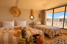 Overnight stay in luxury desert camp camel ride &sandboarding