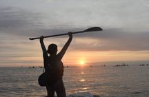 Paddle surfing experience at sunset
