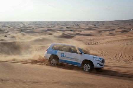 Abu Dhabi desert safari with BBQ, camel ride and sandboarding