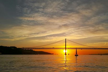 Small-group Lisbon sunset sailing cruise with a welcome drink