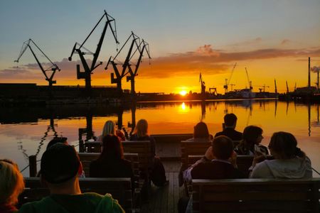 Sunset on the shipyard and old town cruise in Gdansk