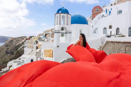 Santorini flying dress photo shoot with a pro photographer