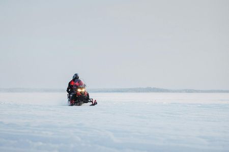 Snowmobile safari through Lappish forest