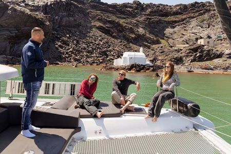 Catamaran cruise along Santorini's coastline from Fira