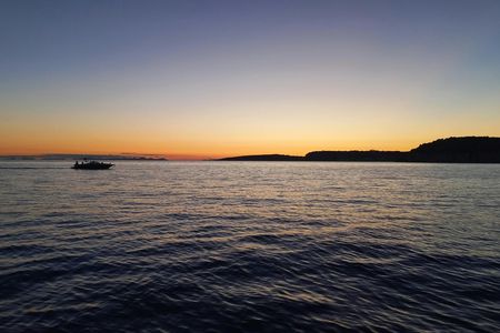 Golden hour boat tour with sunset views of Macarella in Menorca