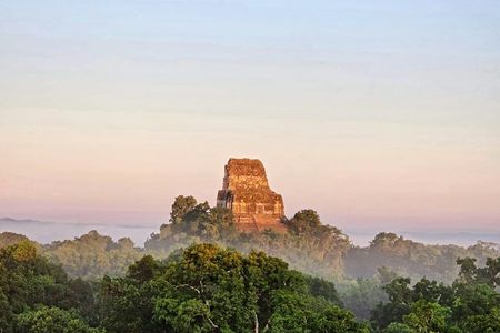 Explore ancient Maya temples on this Tikal sunset tour