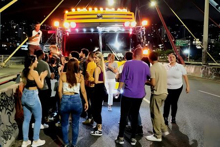 Medellín night tour on an open-air party bus with bar stop