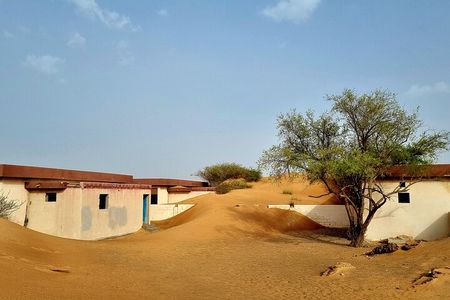 The Ghost Village Safari Tour with Dune Bashing and Sandboarding
