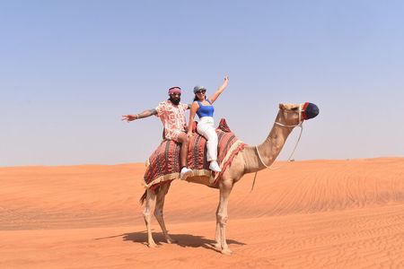 Exclusive Desert Safari Camel Ride Sandboard & Buffet BBQ Dinner