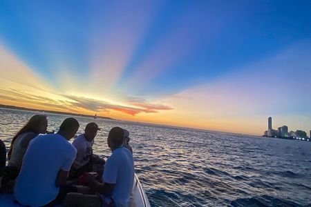 Open bar sunset party in the bay sharing with natives