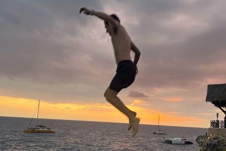 7 Mile Beach Party Catamaran Cruise with Snorkeling & Ricks Cafe 