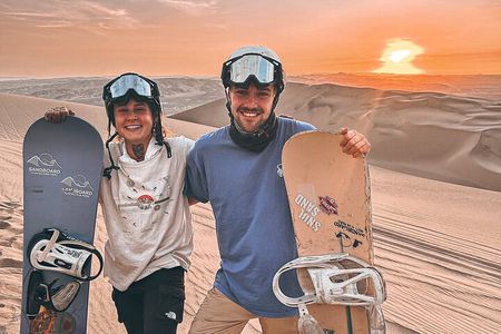 Sandboarding or Sandsky with sunset in Huacachina