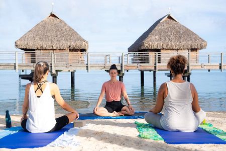 Yoga on the paradise beach of Manava Moorea