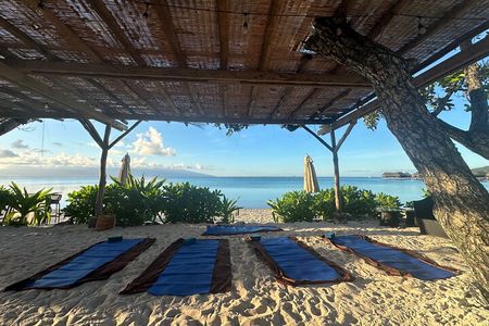 Yoga at sunrise at Sofitel Moorea, overlooking Tahiti