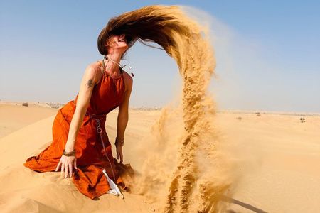 Abu Dhabi Desert Safari with Sandboarding, Camel Ride & Dinner