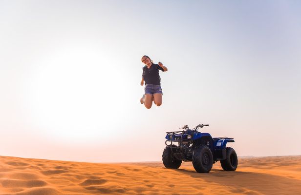 Single quad ride in Dubai Desert with sandboarding, camel ride and BBQ