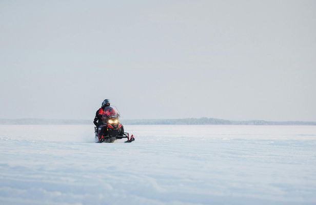 Snowmobile safari through Lappish forest