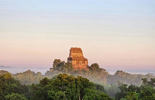 Explore ancient Maya temples on this Tikal sunset tour