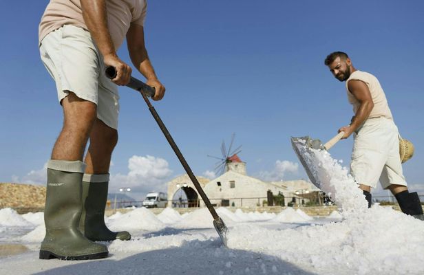 Guided salt harvesting experience in a traditional salt pan