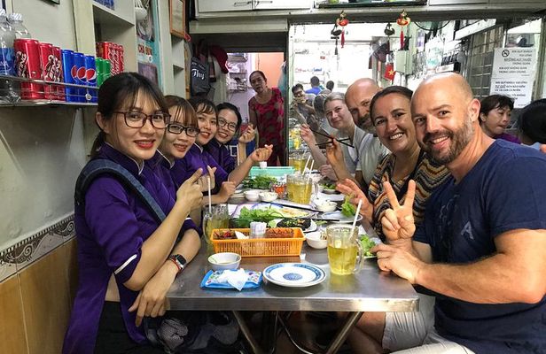 Private Ho Chi Minh Street Food Tour by Motorbike with Ao Dai Female Rider
