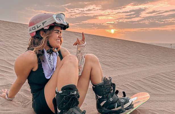 Sandboarding or Sandsky with sunset in Huacachina