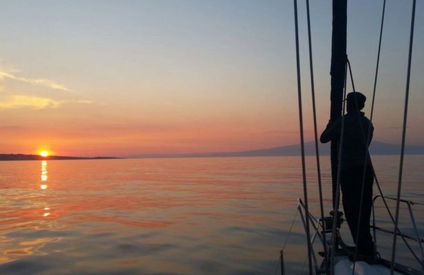 Aperitif on a sailing boat at sunset in Catania