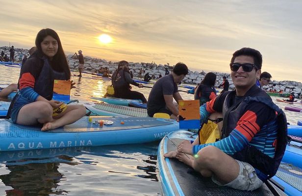 Paddle surfing experience at sunset